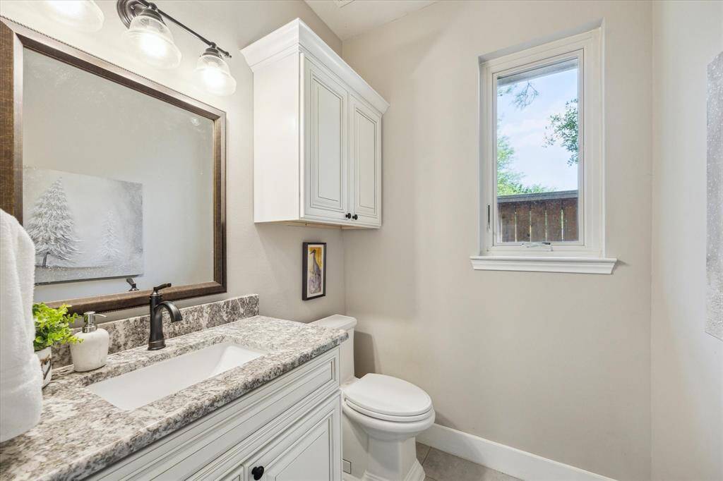 HALF BATH  Slab granite counters grace all of the secondary batroom including the half bath downstairs.  Model home worthy with recent hardware and light fixture.