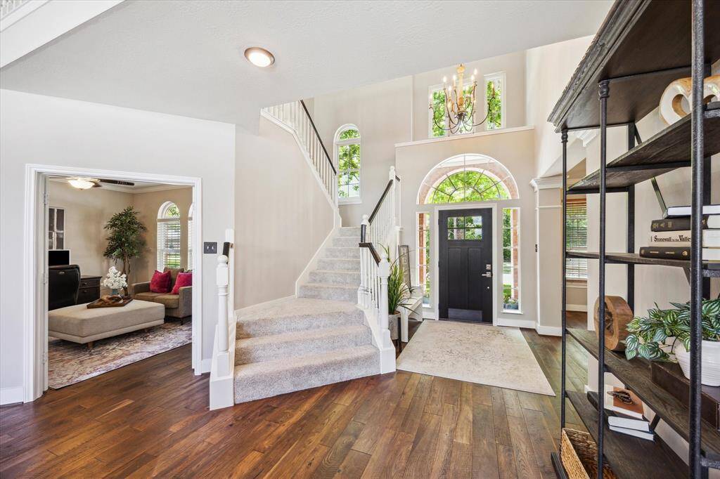 ALTERNATE VIEW OF ENTRY/STUDY  The home office at left is beyond French doors and the dining room at right (not shown) adds to the well appointed floorplan.  Pretty, neutral and pristine paint is throughout the home.