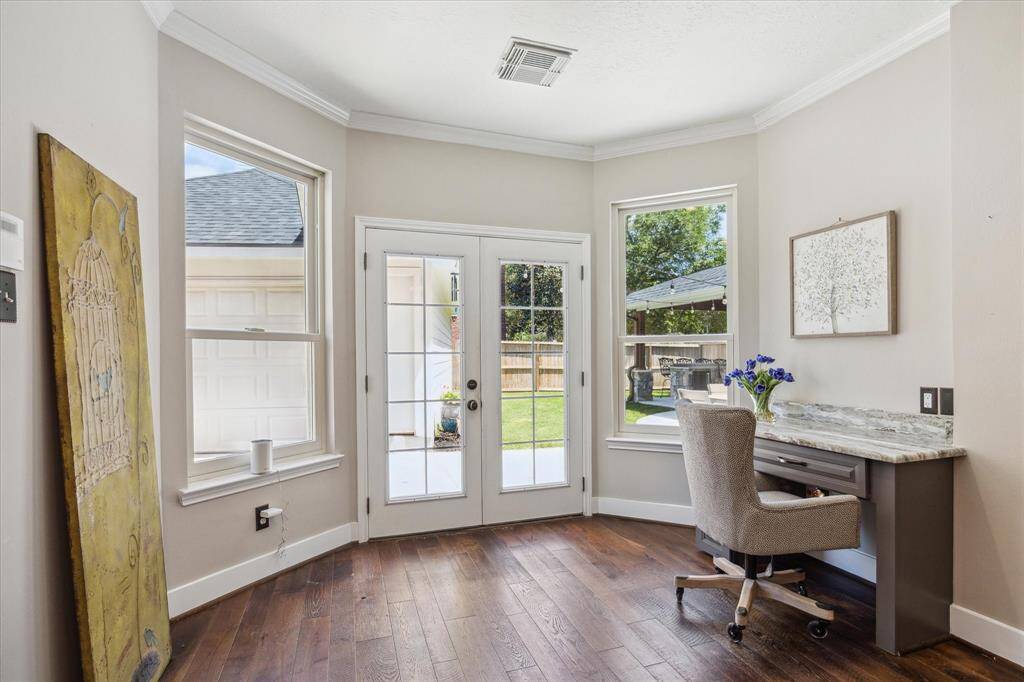 BREAKFAST AREA  A view of the private backyard can be enjoyed through the upgraded windows in this sizable morning room. A smart built in home organization desk is adorned with a matching granite countertop at right.  A table with seating will also fit easily in this space.
