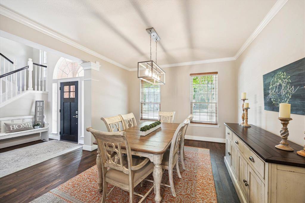 ALTERNATE VIEW OF DINING  From this angle, the wooded preserve across from the house is barely visible through the Anderson windows.  No neighbors across affords privacy and peaceful views.