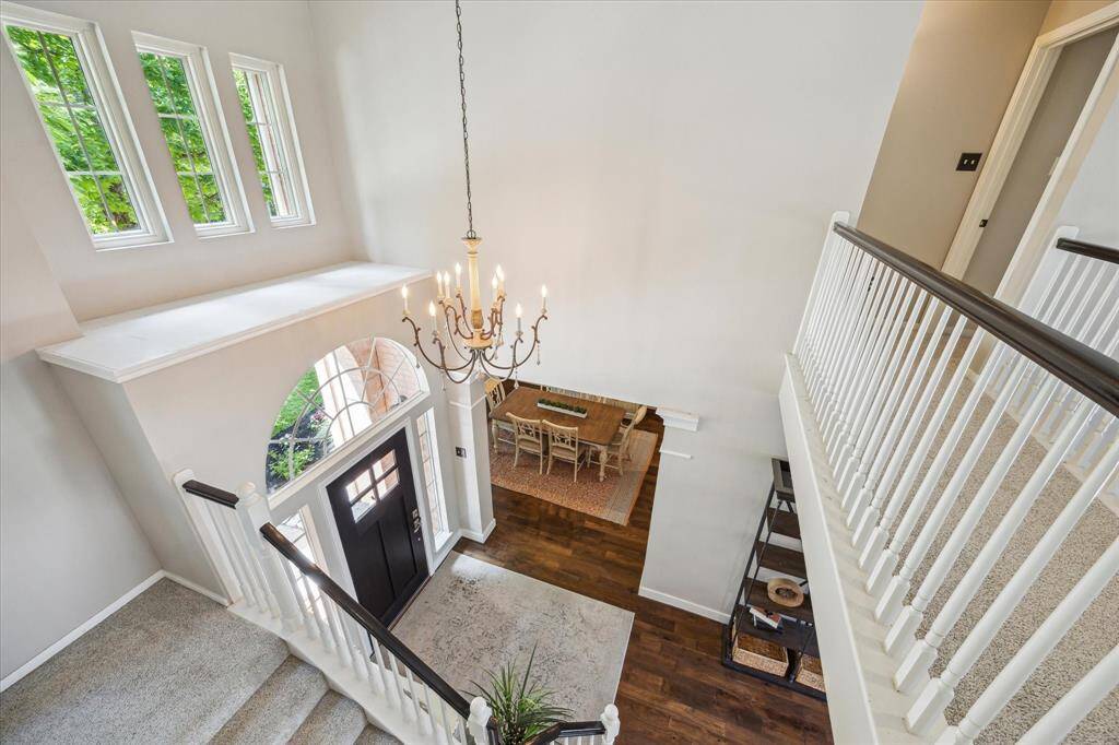 VIEW FROM TOP OF THE STAIRWELL  Striking architecture includes the zigzag staircase that overlooks the entry.  Pretty upgraded chandelier will convey with the home.