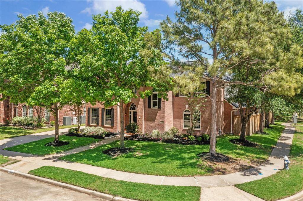 FRONT/SIDE ELEVATION  Positioned on a coveted oversized corner lot embraced by towering mature trees.  Recent roof (March 2025).  One of only a handful of homes on this block tucked in the rear of the neighborhood, no through traffic.