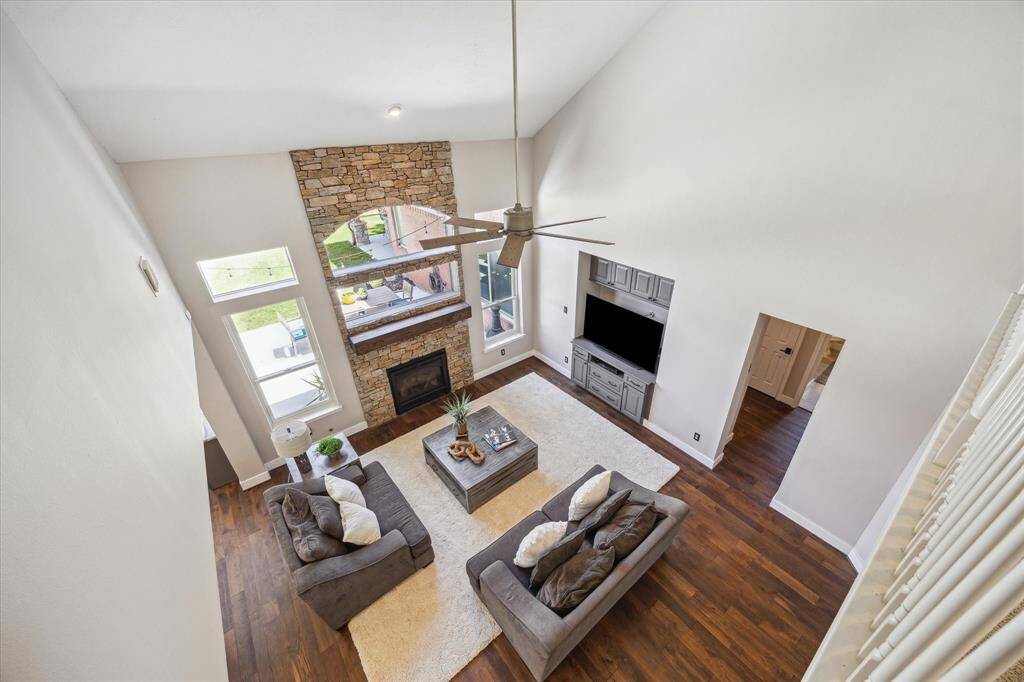 LIVING AREA  A catwalk overlooks the huge family room.  Door at right leads to the half bath and enclave leading to the primary suite.
