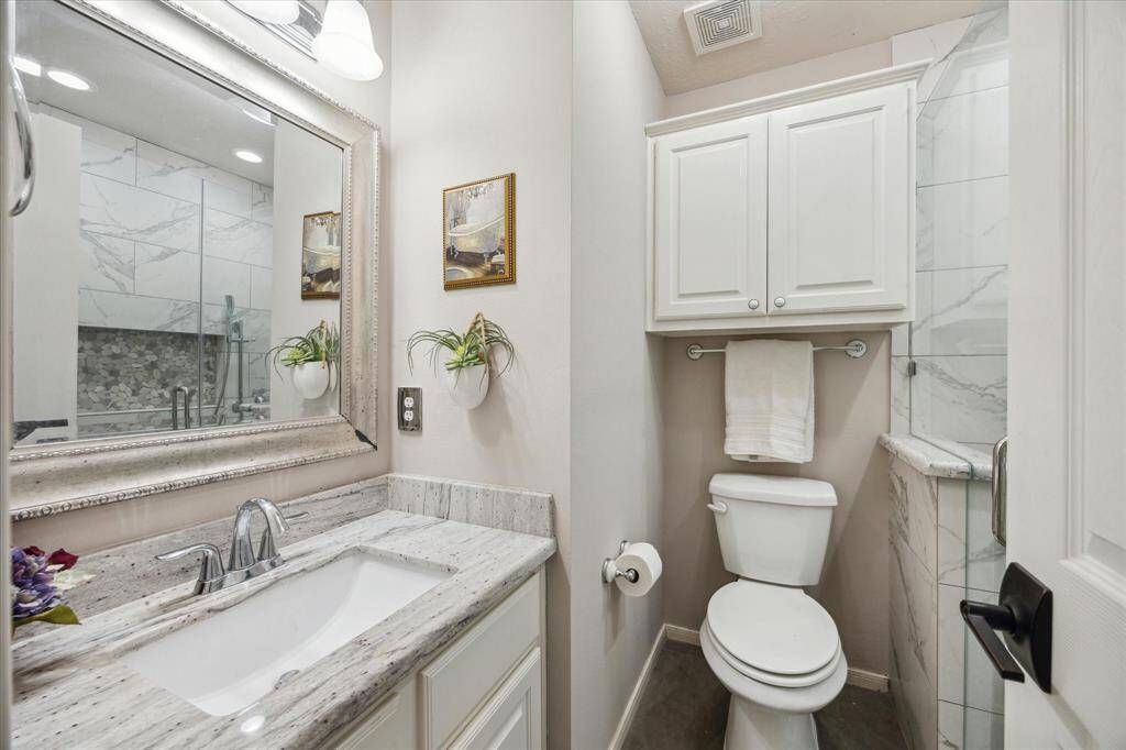 ENSUITE BATH UPSTAIRS  Guests will be delighted with this private, totally remodeled bathroom.  Walk in shower has bench seating.