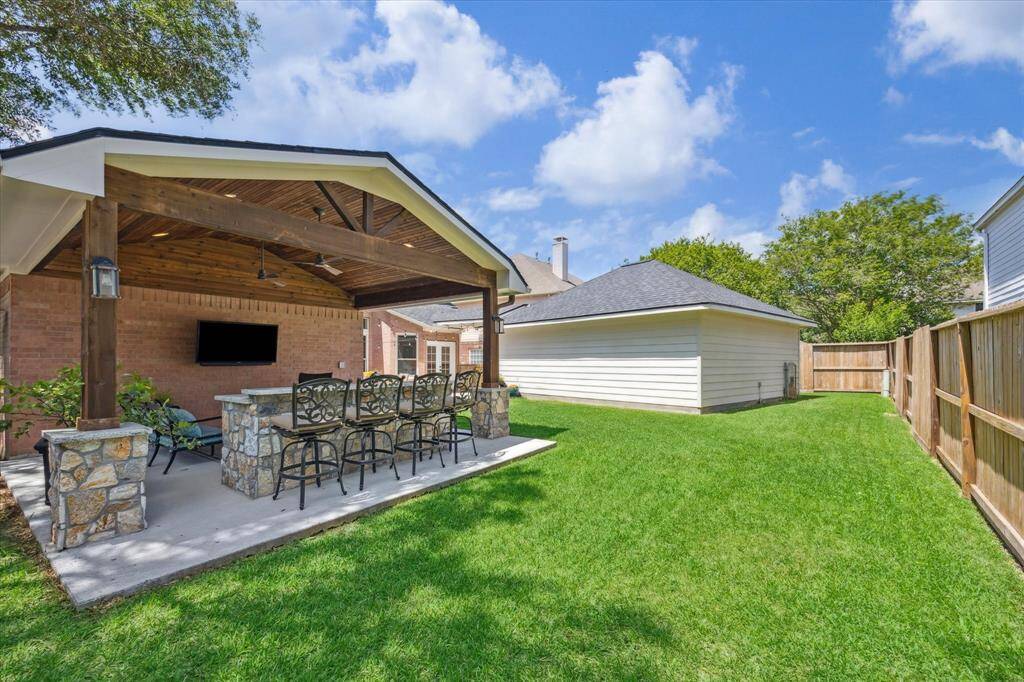 BACKYARD  Carpetlike St. Augustine grass is plush thanks to a full automatice sprinkler system servig both front and back yards.