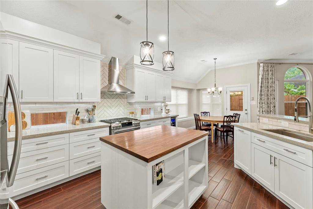 The center island serves as a versatile centerpiece, providing additional workspace and storage.