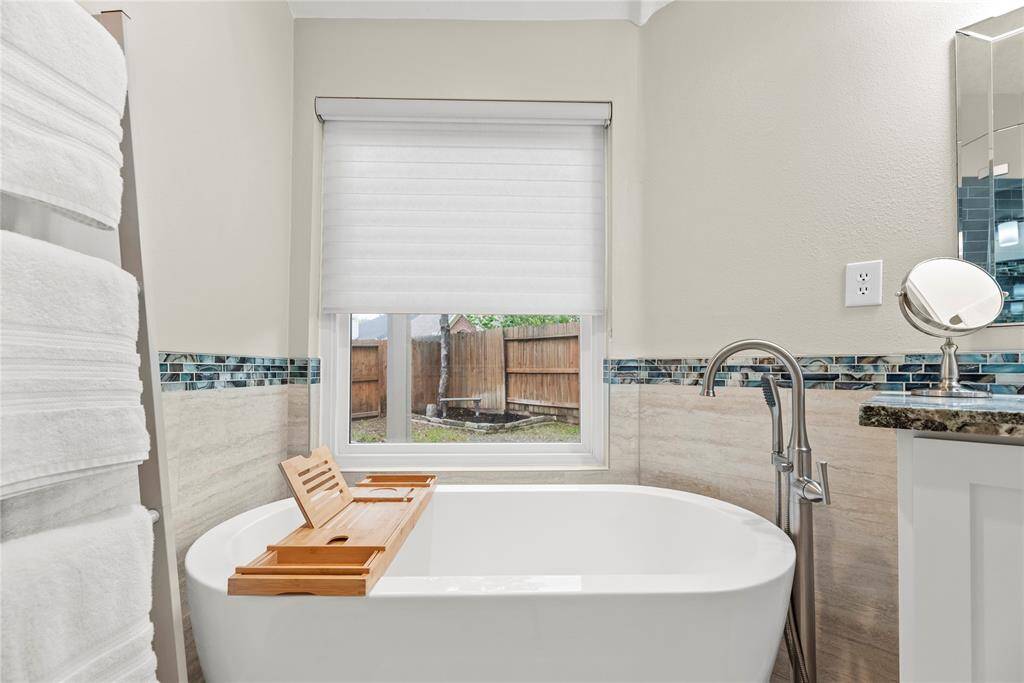 The freestanding soaking tub offers a serene retreat, inviting you to unwind and indulge in pure relaxation.