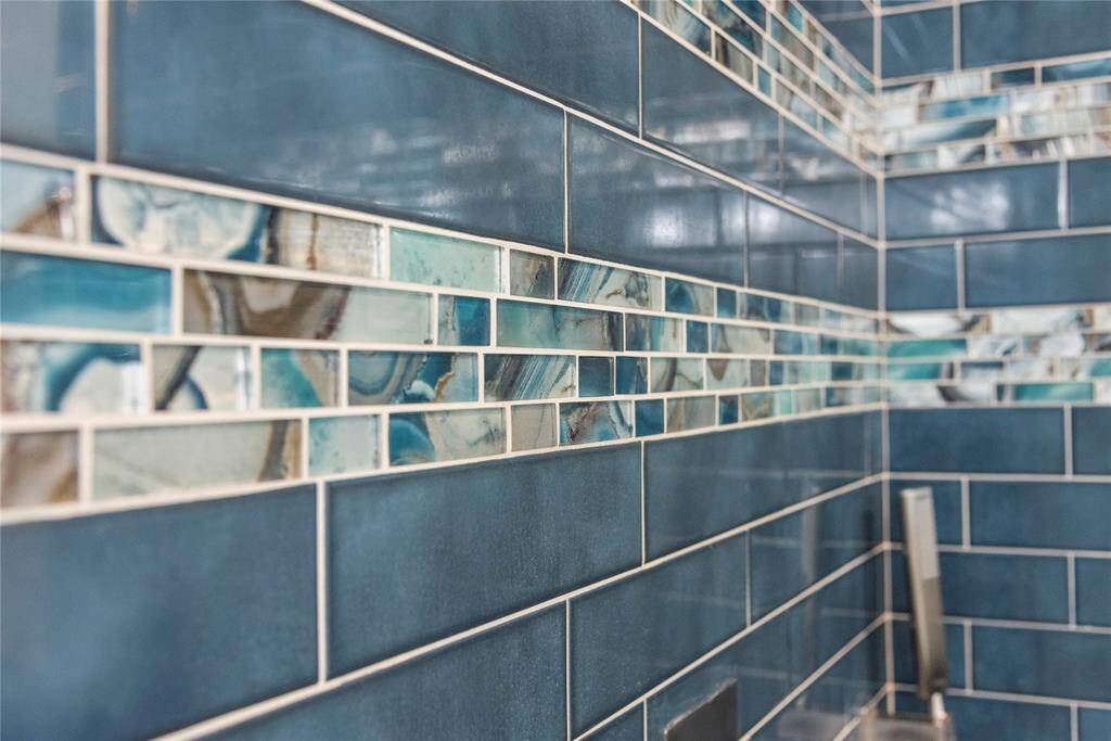 Bathroom showcases exquisite designer tile, adding style and distinction to the space