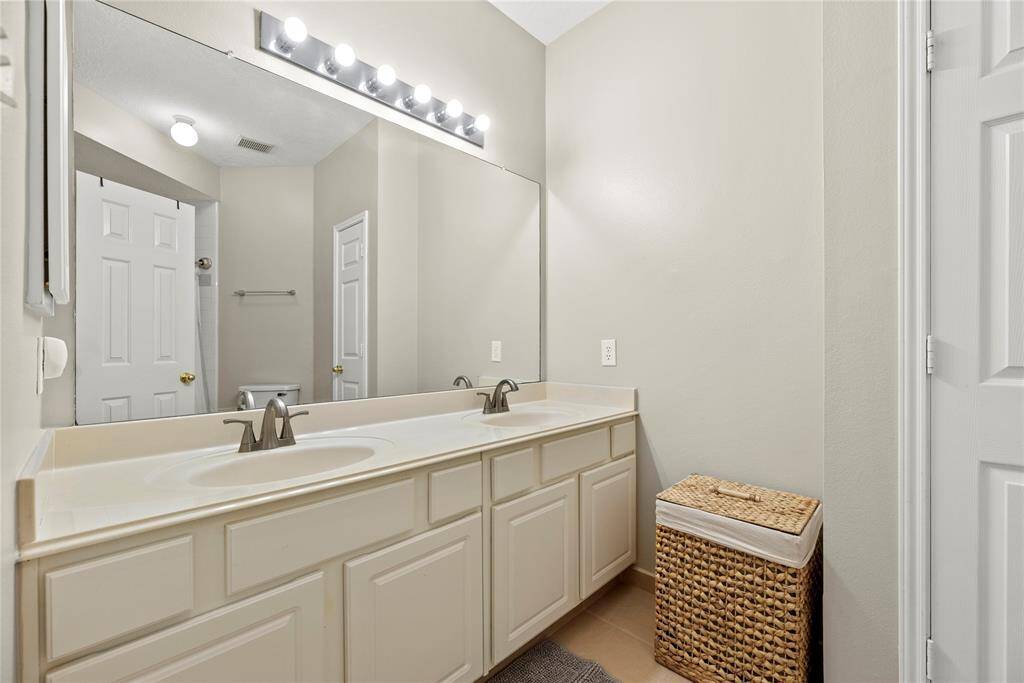The secondary bath features a spacious dual vanity, making busy mornings a breeze for the whole family.