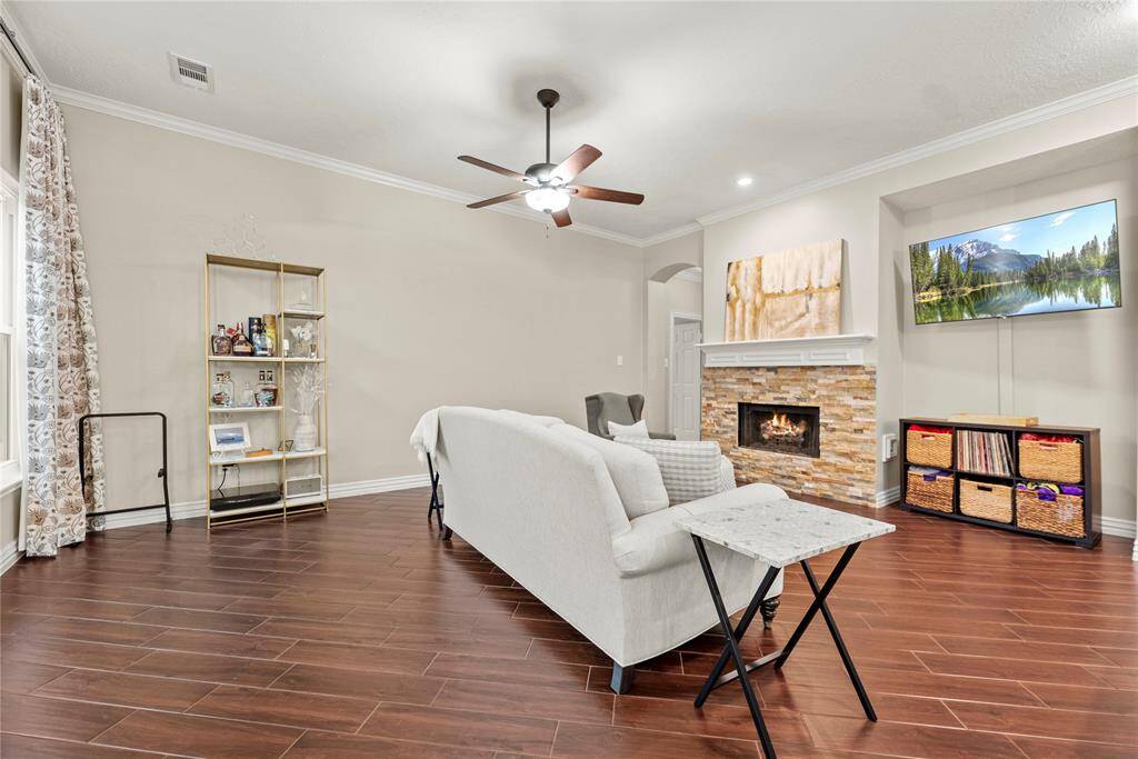 The inviting fireplace becomes a focal point that anchors the room and invites people to gather and linger, making it a cherished feature of the living area.