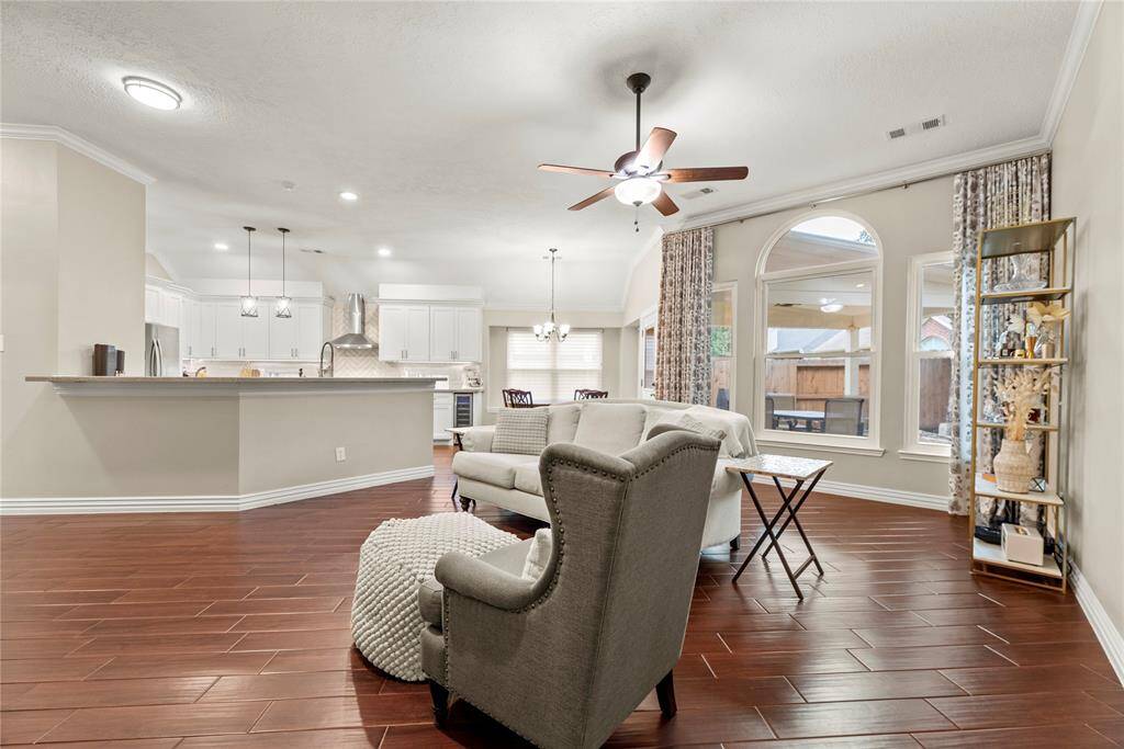 A chic living room space flooded with natural light is delightful! The wall of windows not only brings in abundant sunlight but also offers expansive views of the surrounding landscape, connecting the indoors with the outdoors in a seamless way.