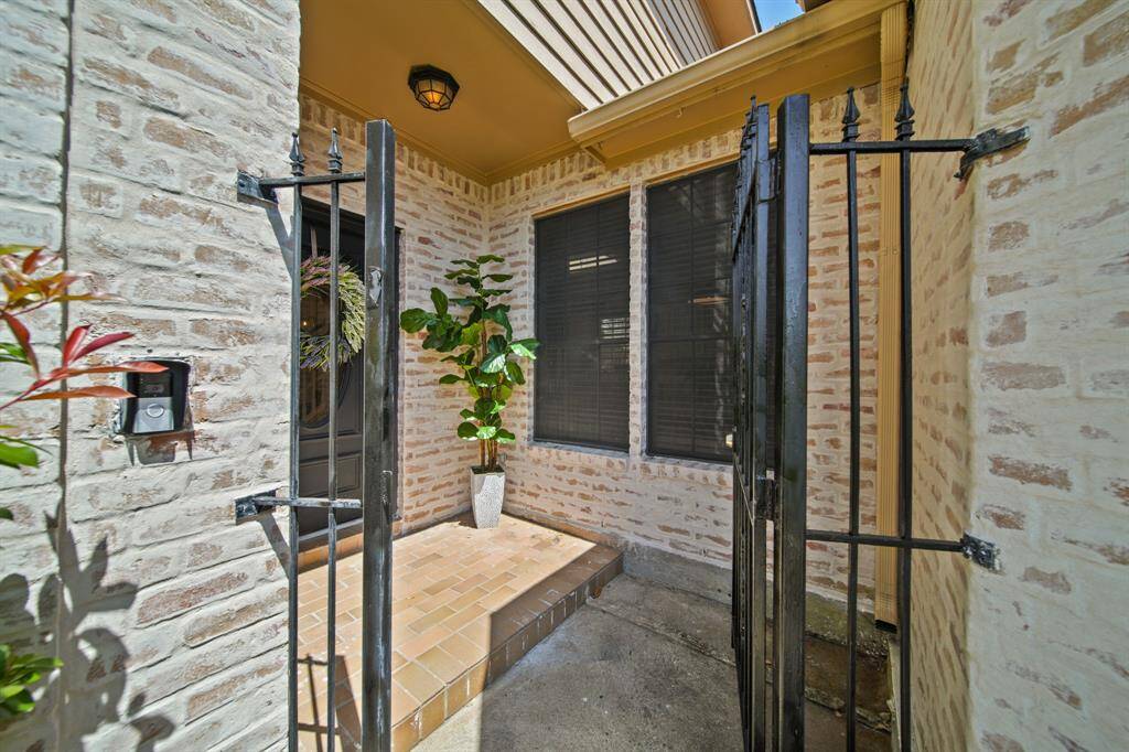 Front porch with iron gate provides a lovely landing zone for your amazon packages.