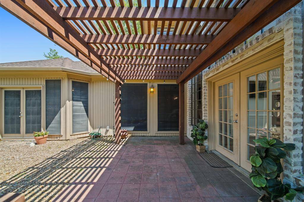 Backyard features a covered porch with access from the Primary bedroom and Family room.