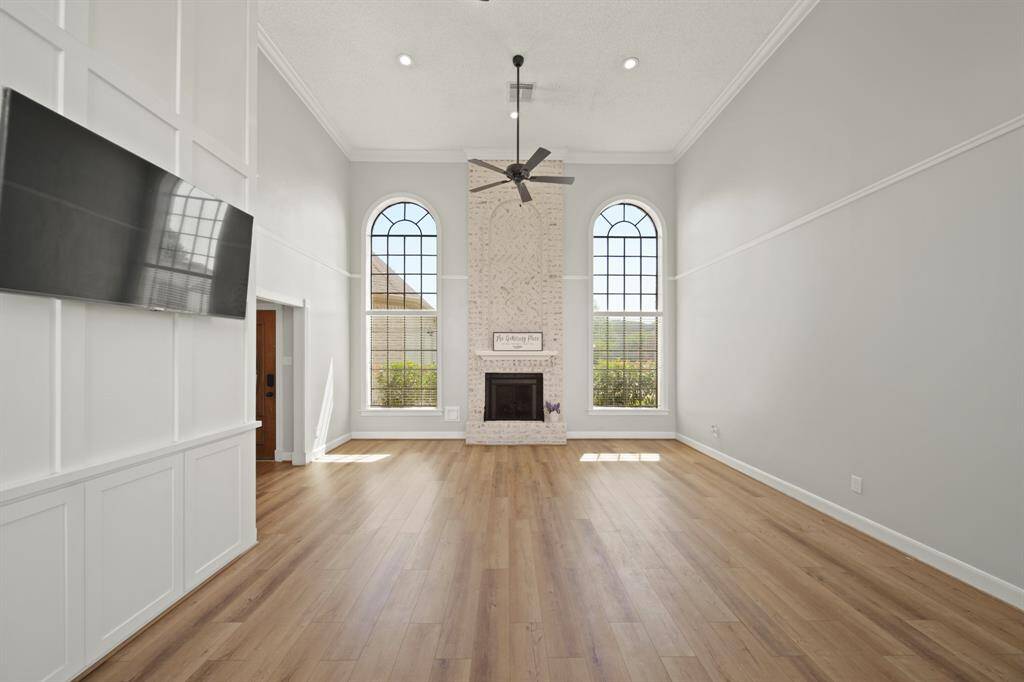 Flanked with windows on both ends, natural light abounds the family room. These are triple paned bronze windows to keep the heat out and let the light in!