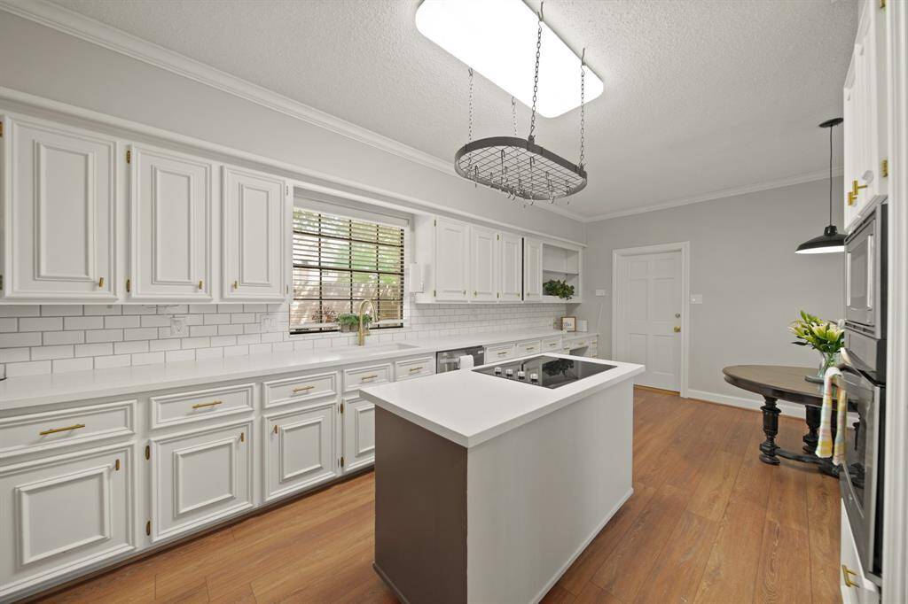 Countertops for Miles in this amazing kitchen.  You'll love the crisp white paint and stylish hardware.