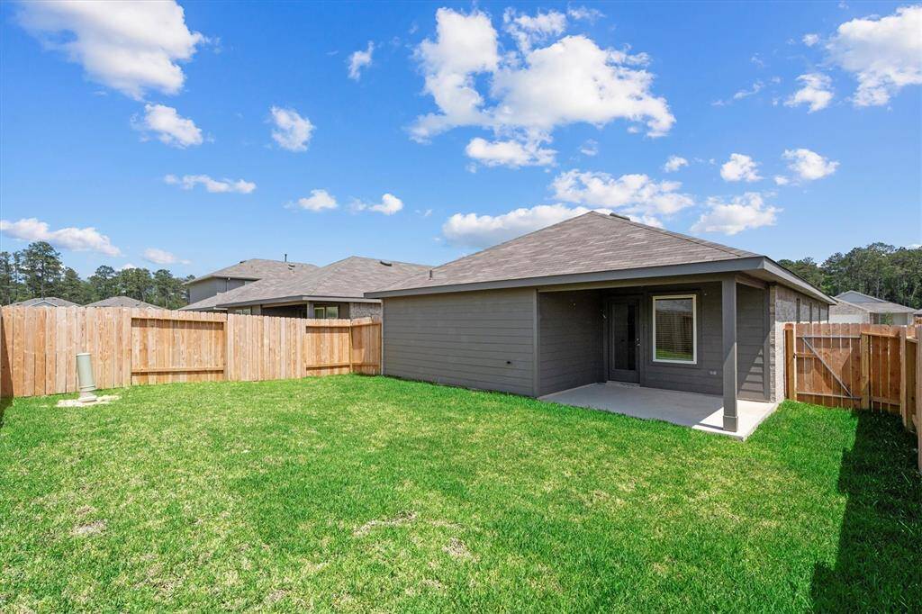 Enjoy outdoor living under a covered patio with a fully fenced backyard—ideal for pets, play, or peaceful relaxation. The yard is lush and low-maintenance, with privacy fencing on all sides.