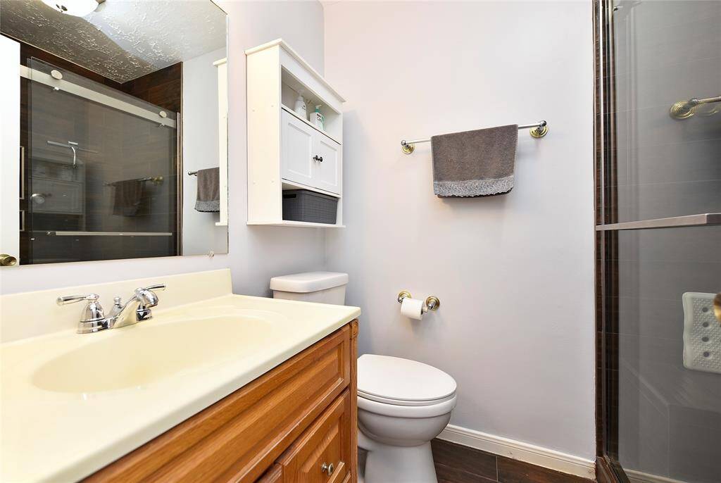 The primary bathroom with updated toilet and shower.