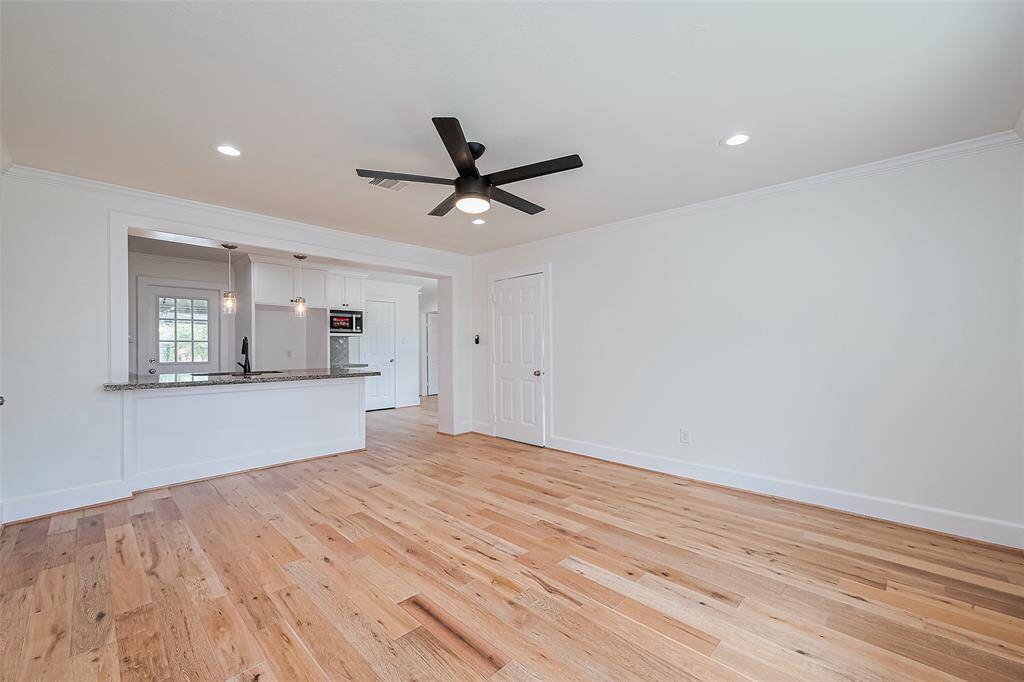 Family room  & kitchen feature New wood flooring.