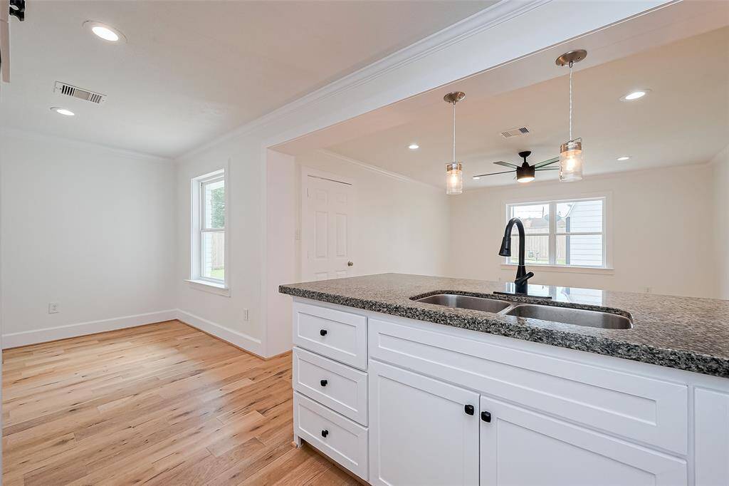 Large granite island with plenty of storage and large dbl sinks