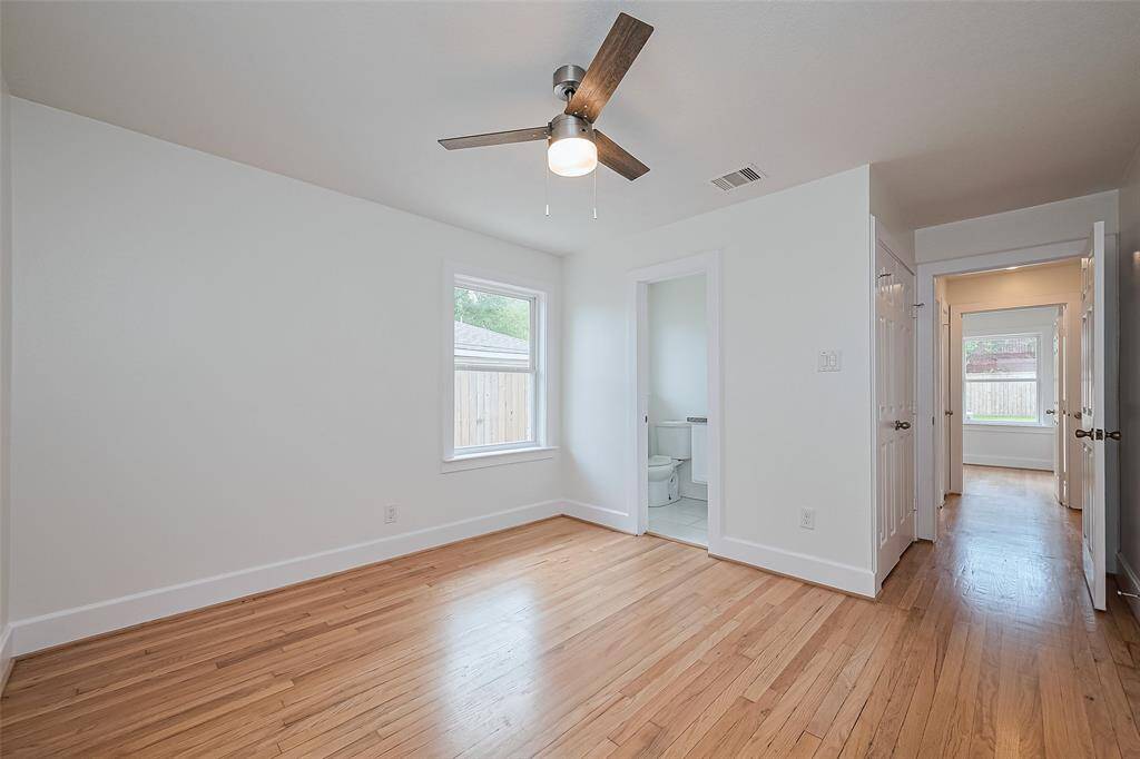 1st Bedroom.  All bedrooms feature dbl pane windows, great natural lighting, Newly refinished wood floors and fans