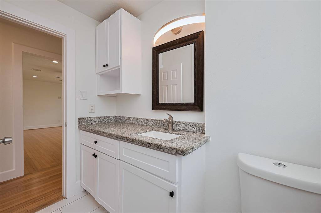 Main bath feature  granite counter, tile floor, new light fixture and large shower