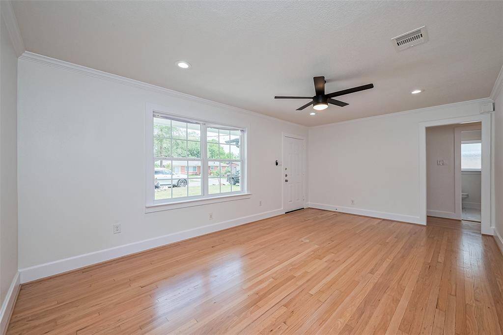 Living room features dbl pane windows, fan & recess lighting