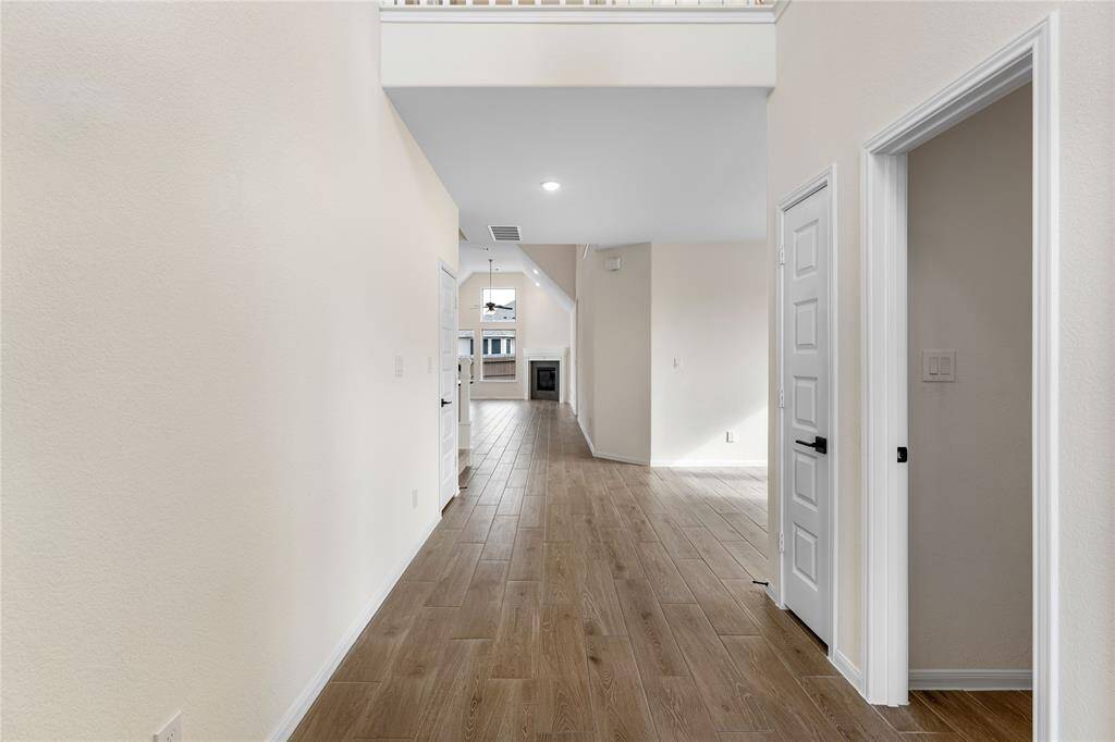 Expansive view of the home from the front door. Notice the upgraded wood-look tile flooring.