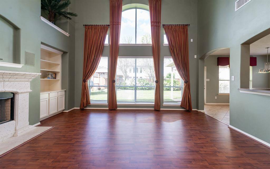 Bright family room with soaring ceilings and expansive windows for abundant natural light.