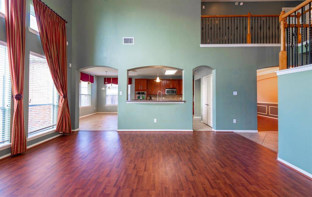 Spacious family room overlooking a large kitchen, breakfast area, and formal dining room.