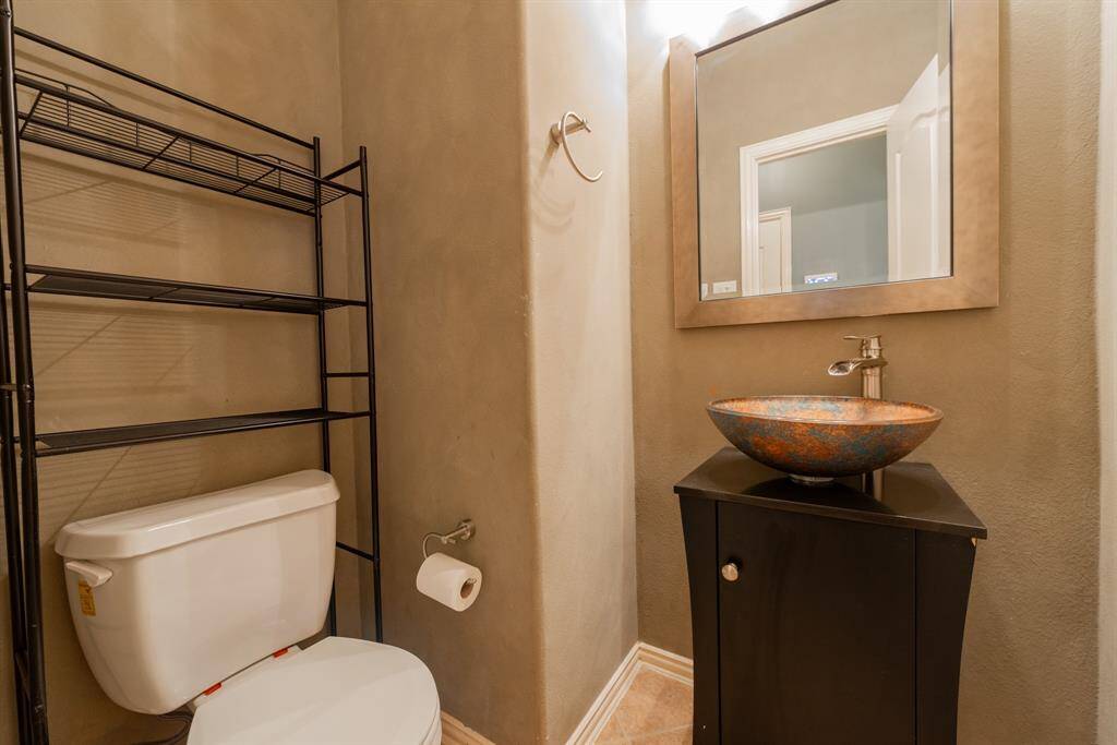 Convenient downstairs half bath with modern fixtures.