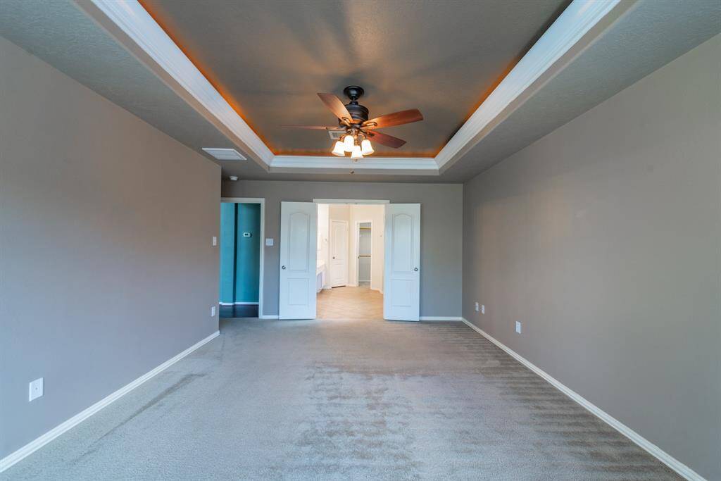 Spacious primary bedroom with an en-suite bath, conveniently located off the family room.