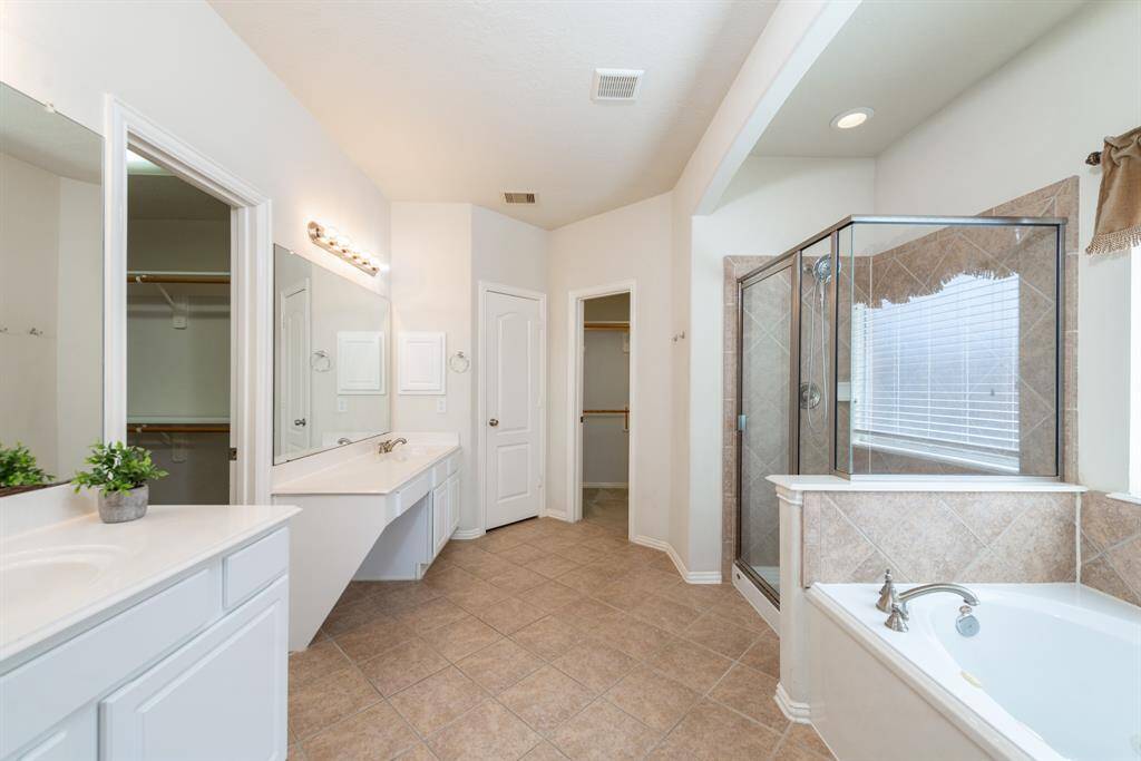 Experience the elegance of the primary bath, featuring a spacious layout, luxurious shower, and a relaxing soaking tub.