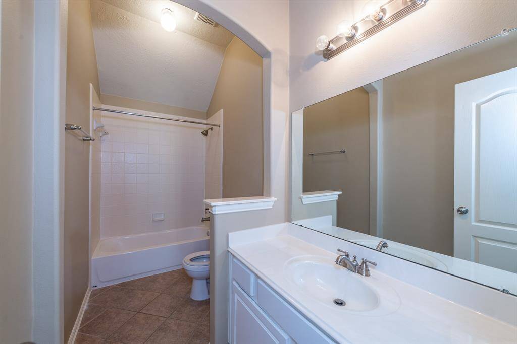 Upstairs secondary bath with a spacious vanity and combined tub/shower.