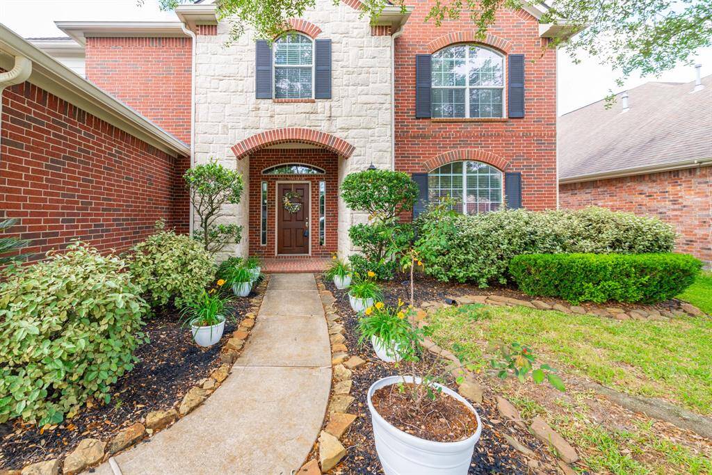 Lush, meticulously maintained landscaping enhances curb appeal and showcases homeowner pride.