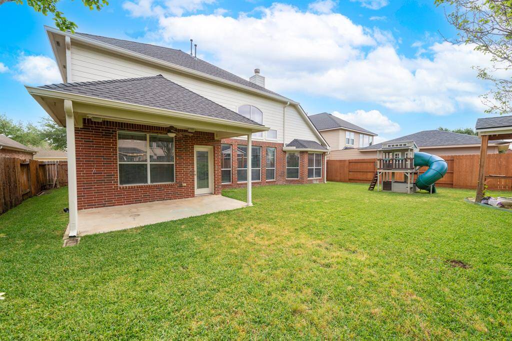 Charming covered patio perfect for relaxing evenings while watching the kids play.