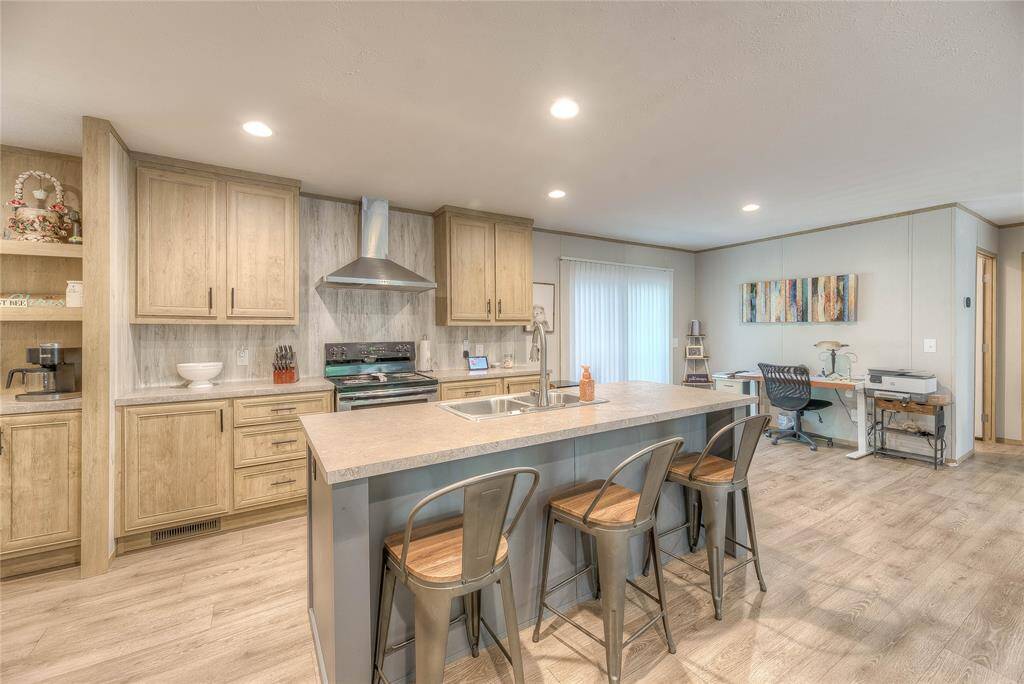 Kitchen has lots of cabinets and counter tops
