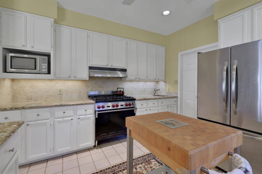 Plenty of cabinet space and prep room with the deep countertops to fit around the commercial range
