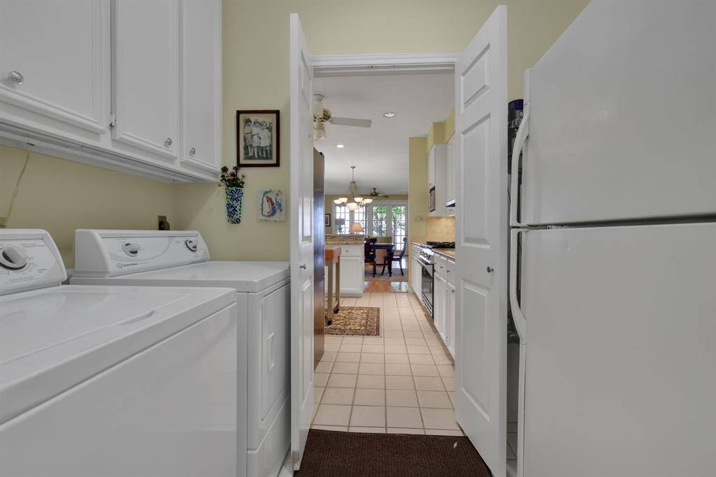 The laundry room is between the kitchen and attached garage