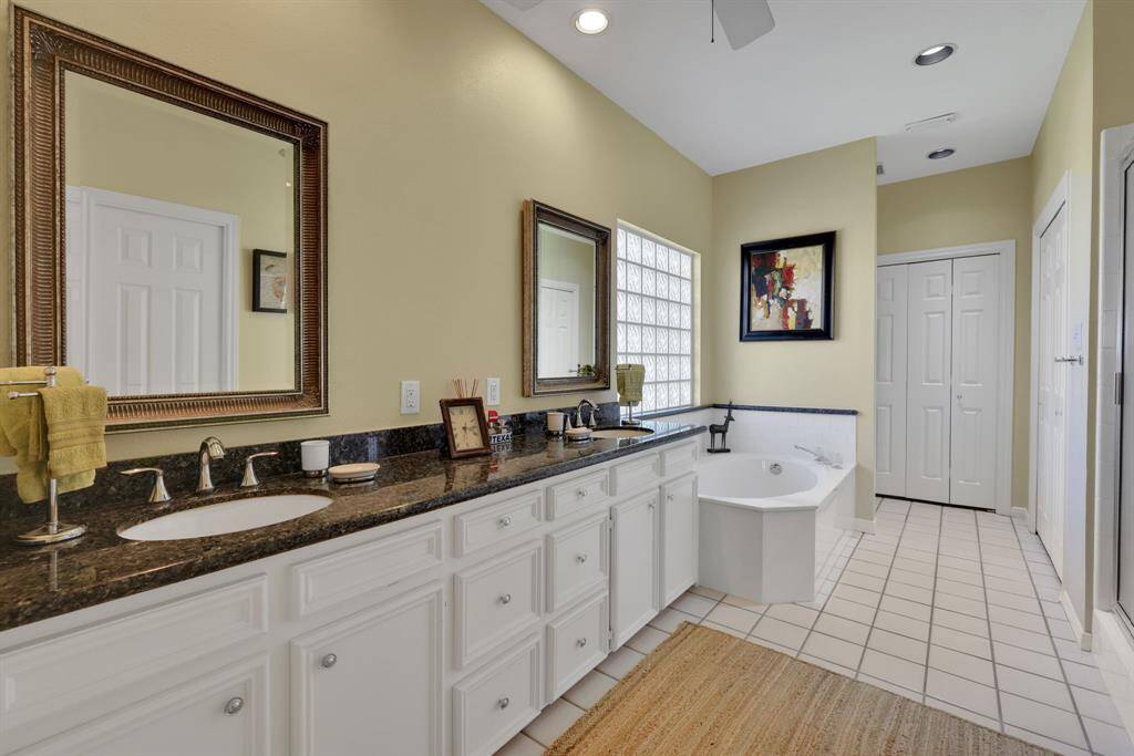 The primary en-suite bathroom has dual sinks, soaking tub and separate shower