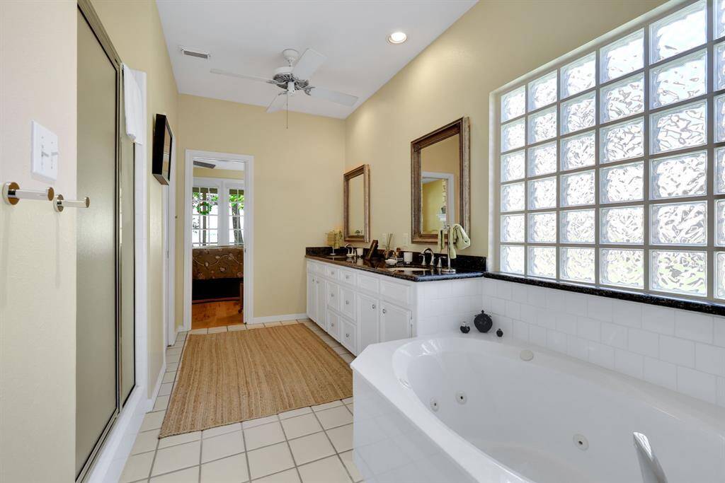 The primary en-suite bathroom has a walk in closet along with two linen closets