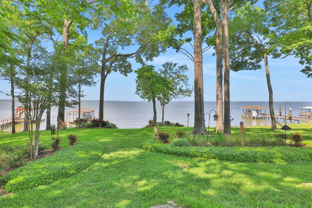 The thoughtfully placed boathouse on one side of the lot preserves the wide-open views from the yard