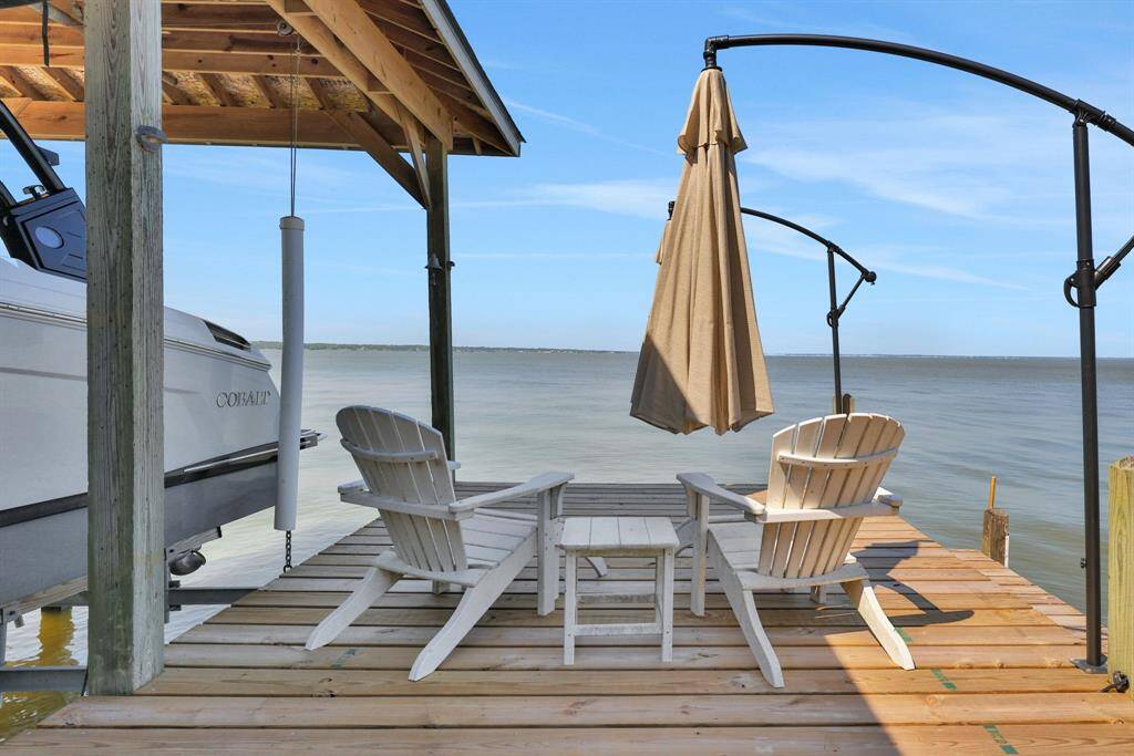 Enjoy the lake breeze from the seating area on the boat house with built in umbrellas