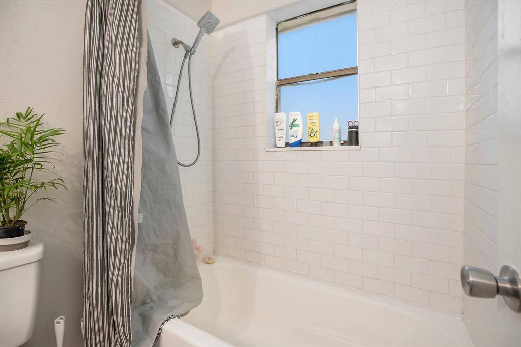 View of the tub/shower in the Primary Bathroom to soak or rinse the day away!