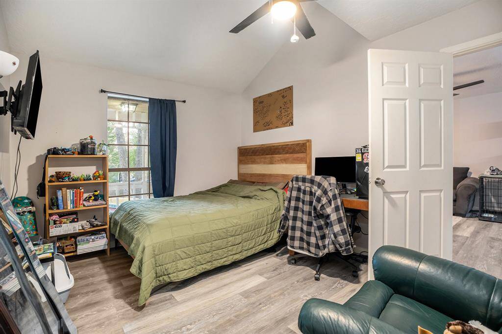 Spacious Secondary Bedroom with updated flooring, raised ceilings and ceiling fan with lighting.