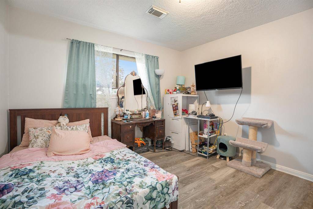 Additional Secondary Bedroom with upgraded flooring, natural lighting and an abundance of space.