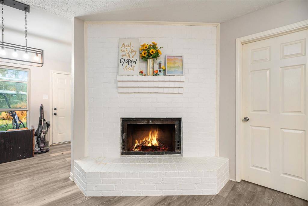 Fantastic Fireplace to cozy up next to on those colder nights with brick surround and shelving for decor.