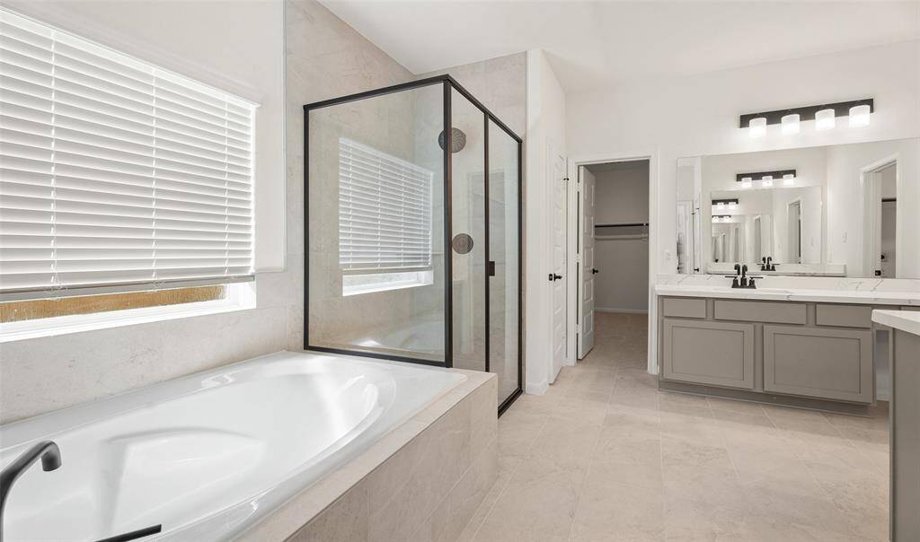 Owner's bath with dual sinks, soaking tub, and separate shower (*Photo not of actual home and used for illustration purposes only.)