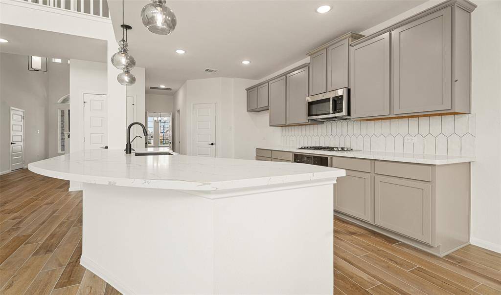 Beautiful gourmet kitchen with quartz countertops (*Photo not of actual home and used for illustration purposes only.)