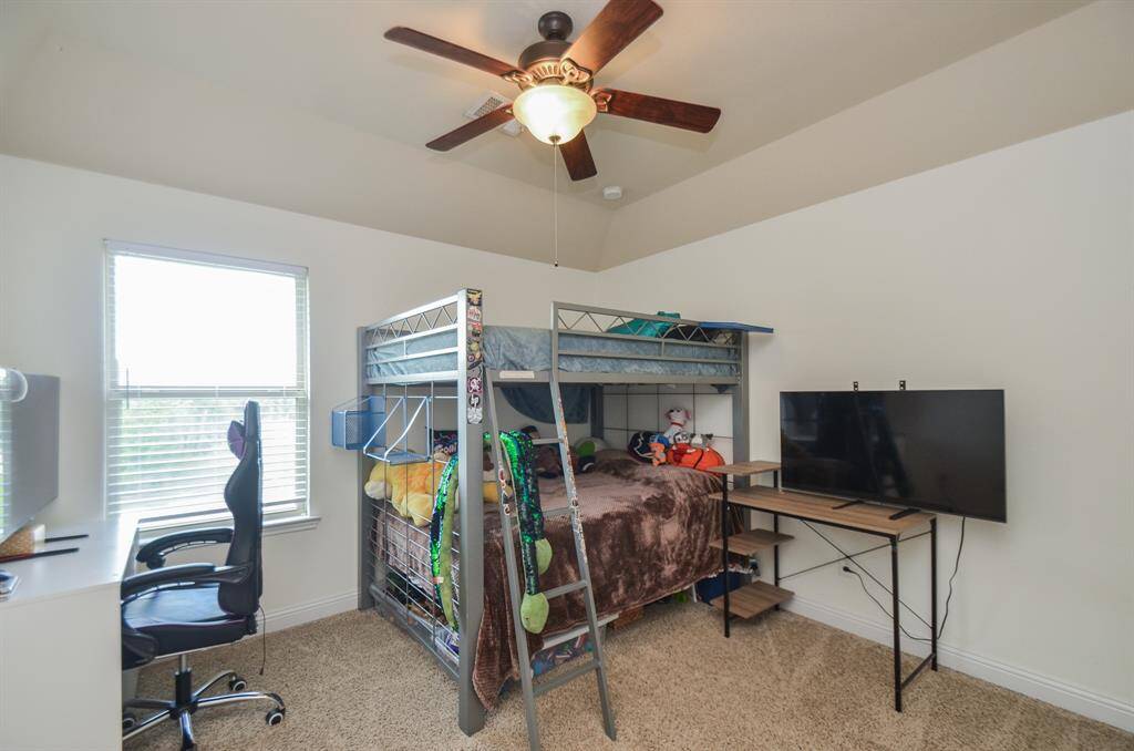 Up or down, bedding choices easily fit in a spacious secondary, carpeted bedroom.