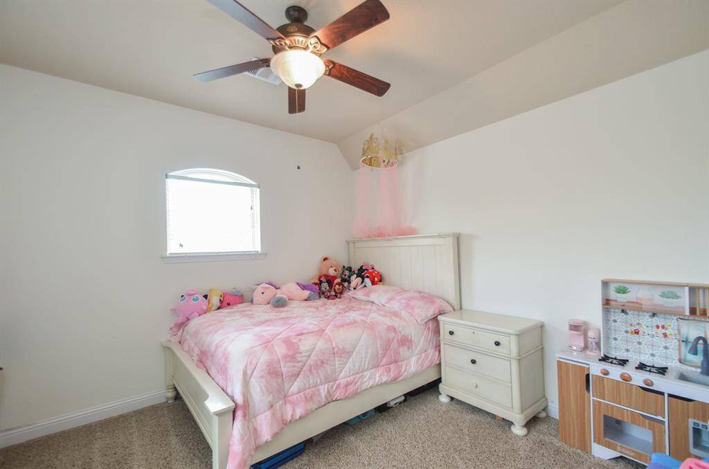 Another large carpeted secondary bedroom has room for sizeable pieces and accents.